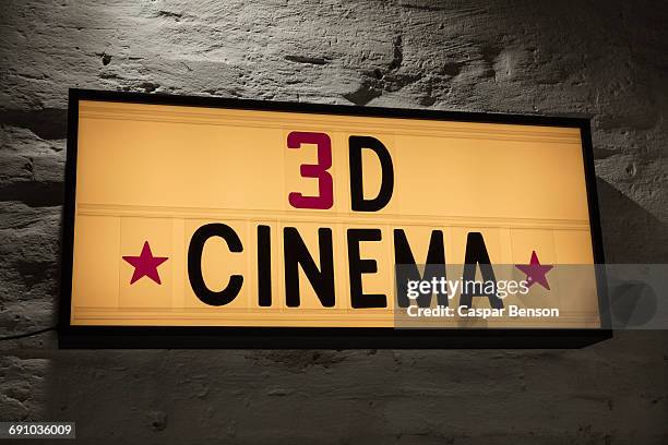 close-up of 3d cinema signboard against gray wall - 3 d letters stock-fotos und bilder