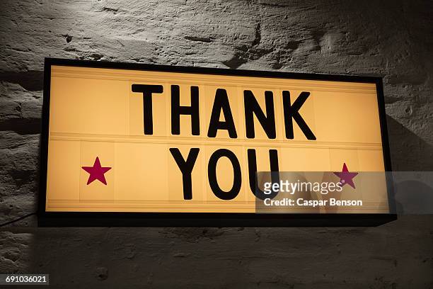close-up of thank you signboard against gray wall - thank you stock pictures, royalty-free photos & images