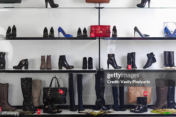 various shoes and purses displayed on shelves at store - leather boots stock pictures, royalty-free photos & images