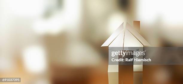 digitally generated image of torn house over colored background - finance and economy photos stock illustrations