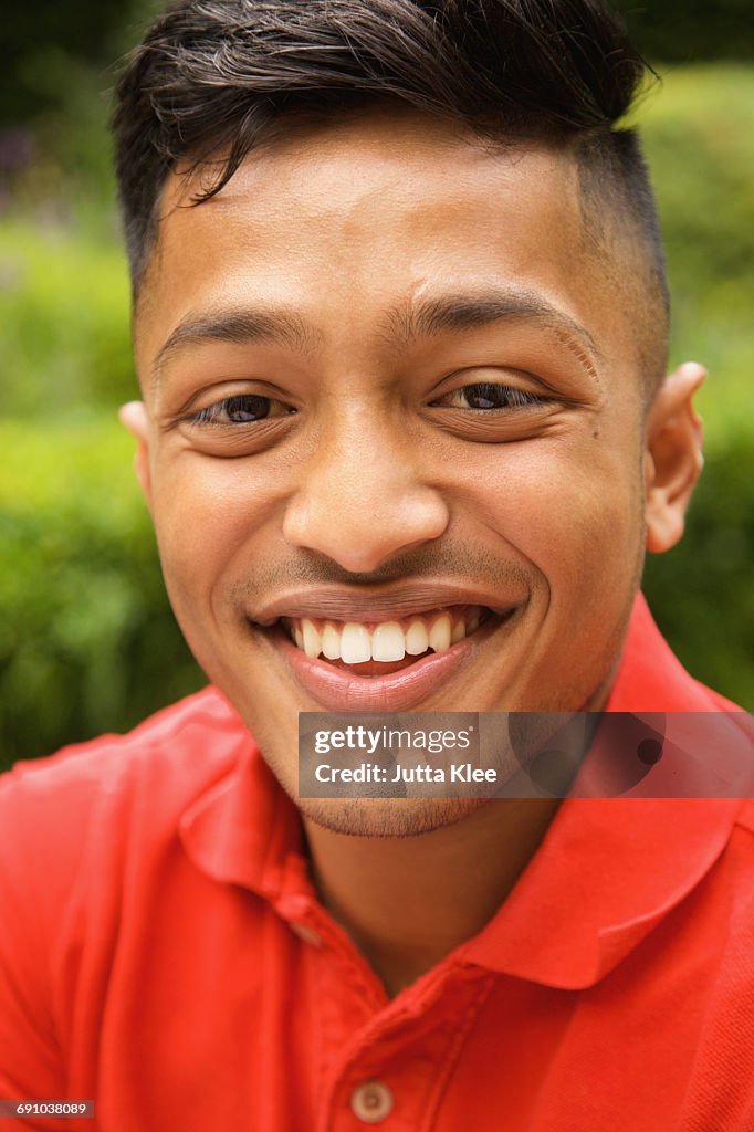 Close-up portrait of happy young man at yard