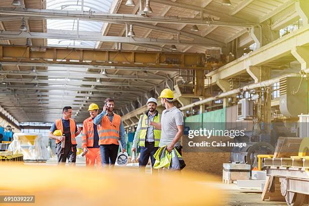 steel workers walking and talking in factory - steel worker stock pictures, royalty-free photos & images