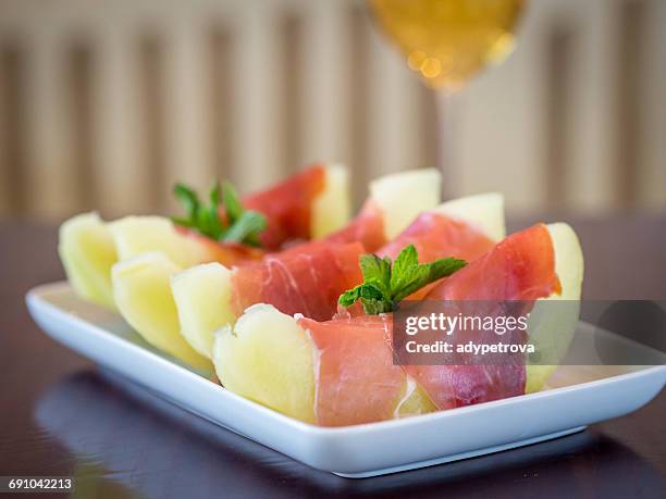 melon wrapped in parma ham - prosciutto wrapped stock pictures, royalty-free photos & images