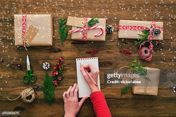 girl with blank note pad and christmas gifts - wish list stock pictures, royalty-free photos & images