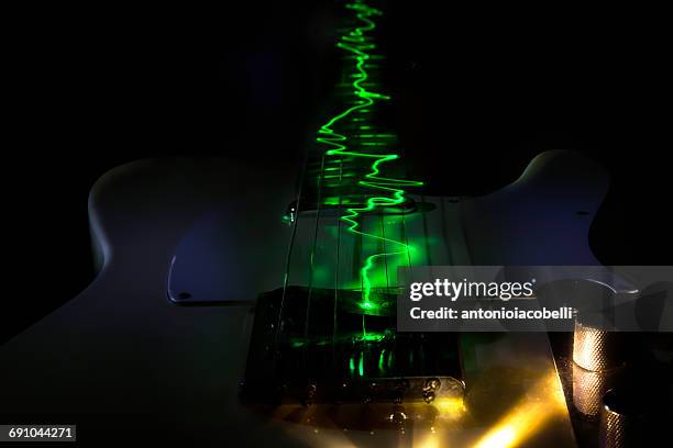 green sound waves coming out of a guitar - oscilloscope stock pictures, royalty-free photos & images