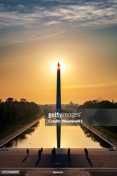 usa, washington dc, view to washington monument at sunrise with soldiers training in the foreground - national monument stock pictures, royalty-free photos & images