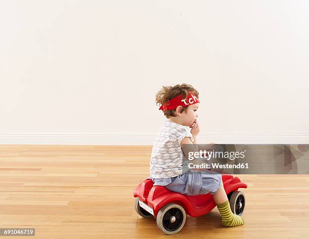 little girl playing with pedal car - macchina a pedali foto e immagini stock