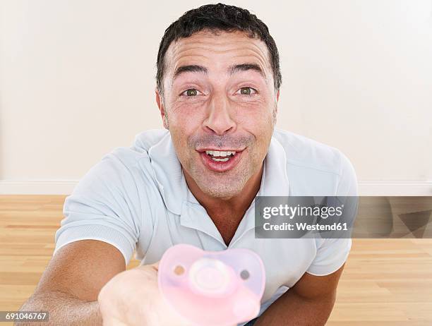 Baby Pacifier Hand Photos and Premium High Res Pictures - Getty Images