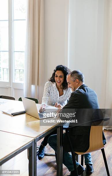 business people working together in office - confident businessman sitting with colleagues in office stock pictures, royalty-free photos & images