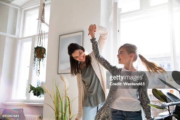 happy mother with daughter at home - active lifestyle stock-fotos und bilder