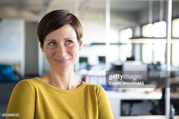 portrait of smiling businesswoman in office - 35 year old woman stock pictures, royalty-free photos & images