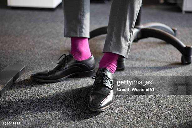 close-up of businessman in office wearing pink socks - socks fotografías e imágenes de stock