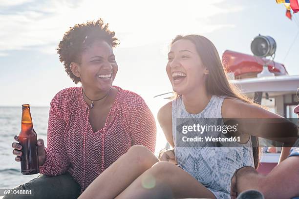 happy friends on a boat trip having a beer - bottle water sport stock pictures, royalty-free photos & images