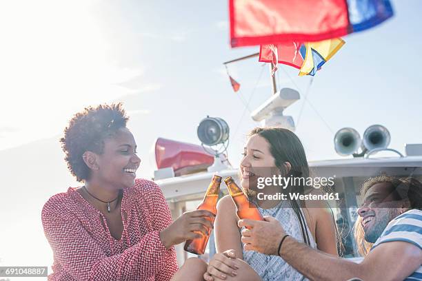 happy friends on a boat trip having a beer - bottle water sport stock pictures, royalty-free photos & images