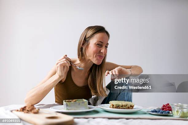 woman preparing vegan matcha cake - healthy baked goods stock pictures, royalty-free photos & images