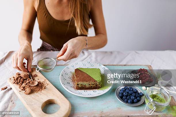 woman preparing vegan matcha cake - teesieb stock-fotos und bilder