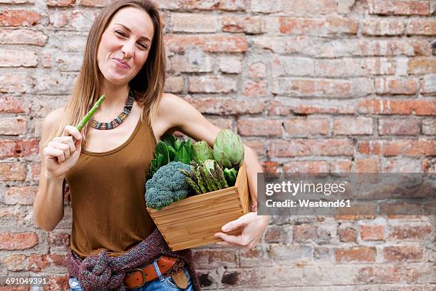 smiling woman holding basket with fresh vegetables - crucifers fotografías e imágenes de stock