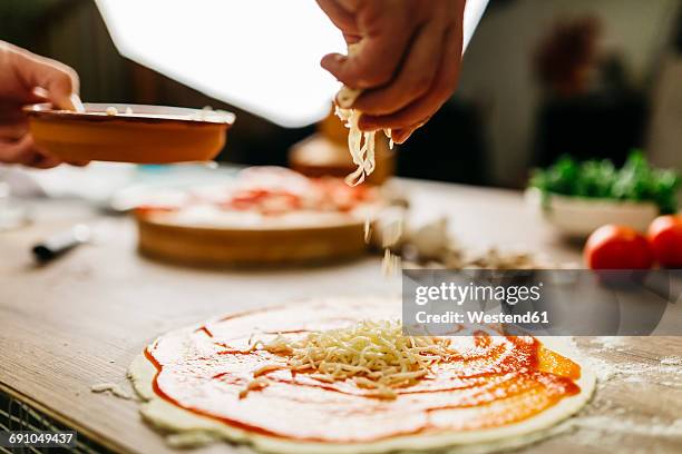 preparing pizza at home - grated cheese stock pictures, royalty-free photos & images