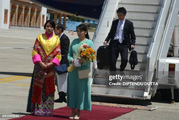 Japanese Princess Mako is welcomed by Bhutan's Princess Euphelma at Paro International Airport in Paro on June 1 at the start of her nine-day...