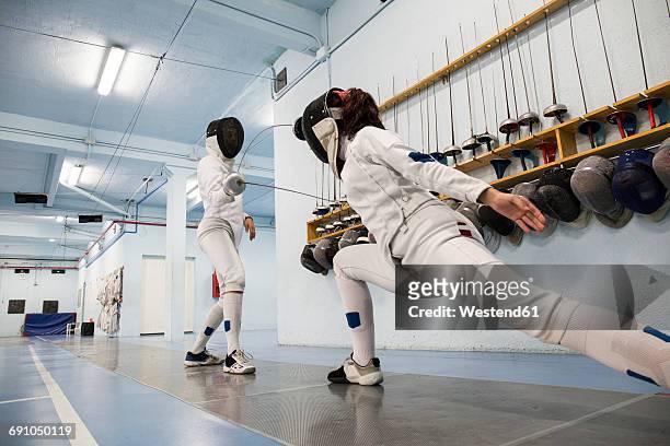 female fencers during a fencing match - face guard sport 個照片及圖片檔