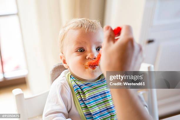 baby boy being fed - spoon feeding stockfoto's en -beelden