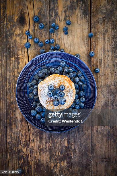 pancakes with blueberries and icing sugar on plate - blueberry pancakes stock pictures, royalty-free photos & images