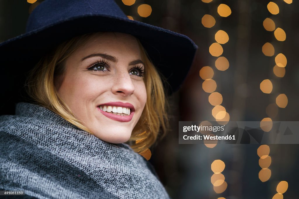 Portrait of smiling young woman wearing hat and scarf