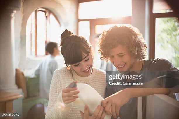 young couple roommates looking at expiration date on milk in kitchen - expiry date stock pictures, royalty-free photos & images