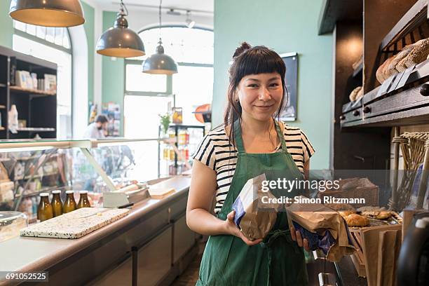 female owner at deli counter in grocery store - shop owner stock pictures, royalty-free photos & images