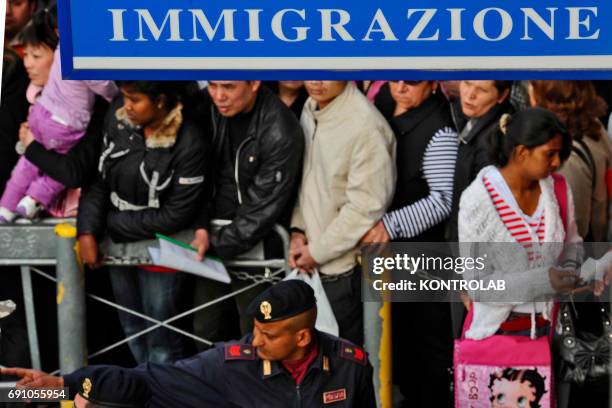 Immigrants stand in line in front of immigration offices downtown Naples in order to have their visa.