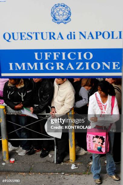 Immigrants stand in line in front of immigration offices downtown Naples in order to have their visa.