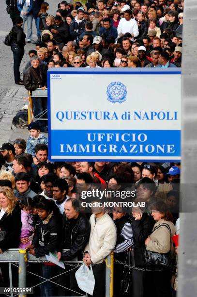 Immigrants stand in line in front of immigration offices downtown Naples in order to have their visa.