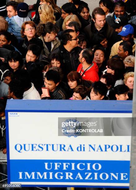 Immigrants stand in line in front of immigration offices downtown Naples in order to have their visa.