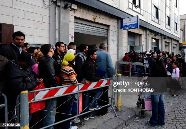 Immigrants stand in line in front of immigration offices downtown Naples in order to have their visa.