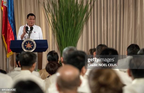 Philippine President Rodrigo Duterte gestures as he gives a speech during the mass oath taking of officials of various national leagues at the...