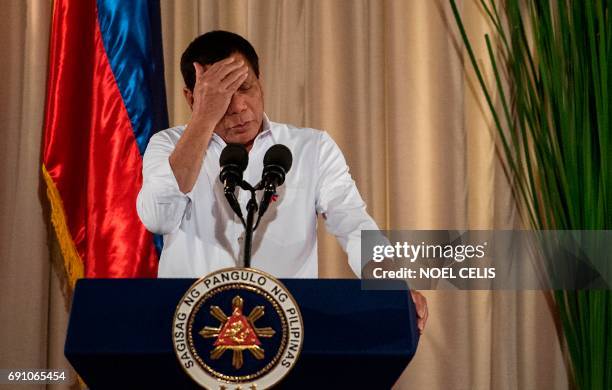 Philippine President Rodrigo Duterte gestures as he gives a speech during the mass oath taking of officials of various national leagues at the...