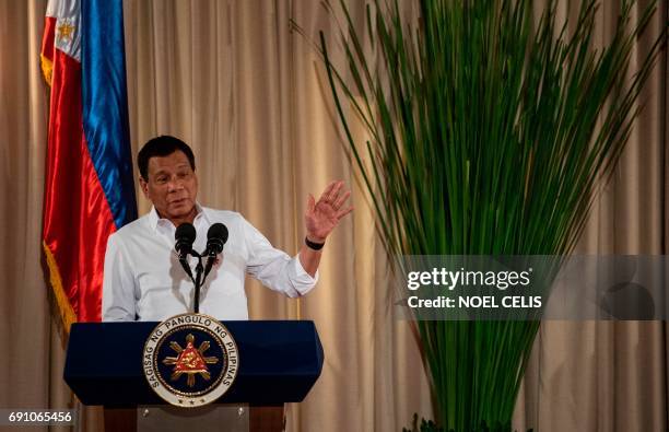 Philippine President Rodrigo Duterte gestures as he gives a speech during the mass oath taking of officials of various national leagues at the...