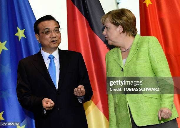 German Chancellor Angela Merkel talks with Chinese Prime Minister Li Keqiang as representatives of both countries sign economic agreements at the end...