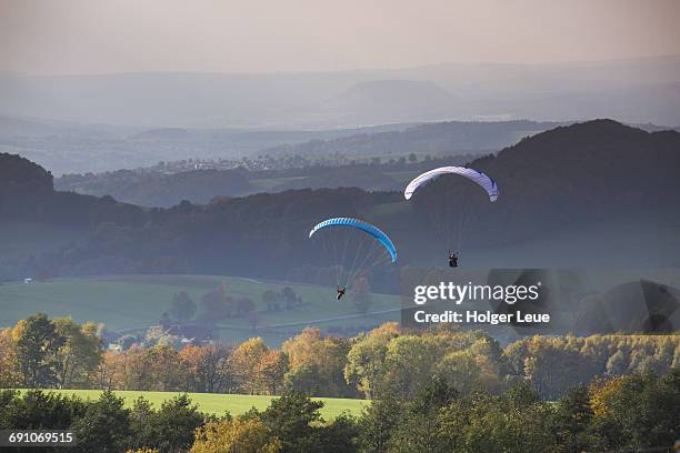 paragliders near wasserkuppe mountain - hesse stock pictures, royalty-free photos & images