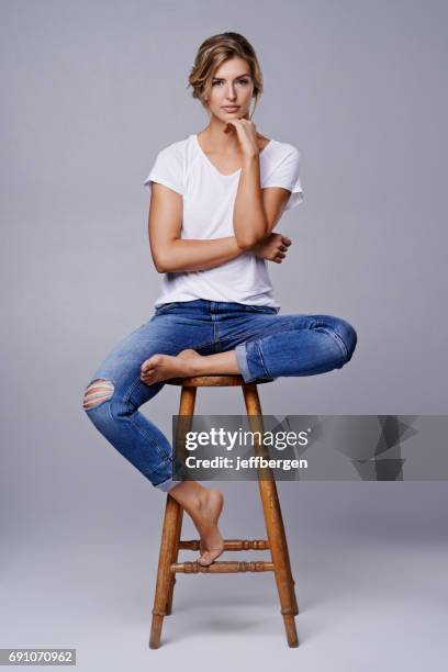 there is beauty is simplicity - women sitting on stools stock pictures, royalty-free photos & images
