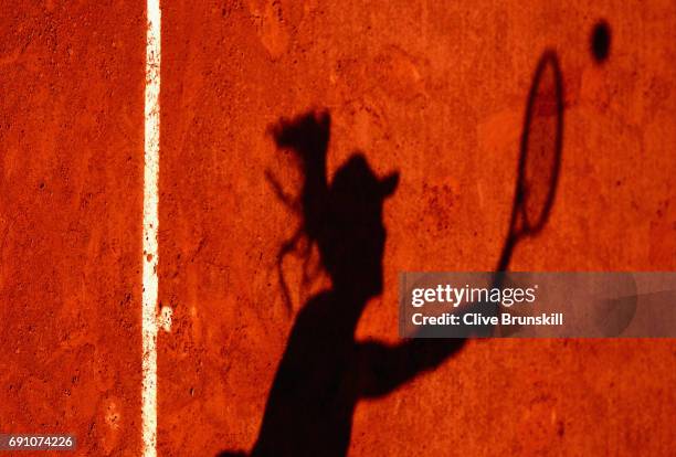 The shadow of Agnieszka Radwanska of Poland is pictured during her ladies singles second round match against Alsion Van Uytvanck of Belgium on day...