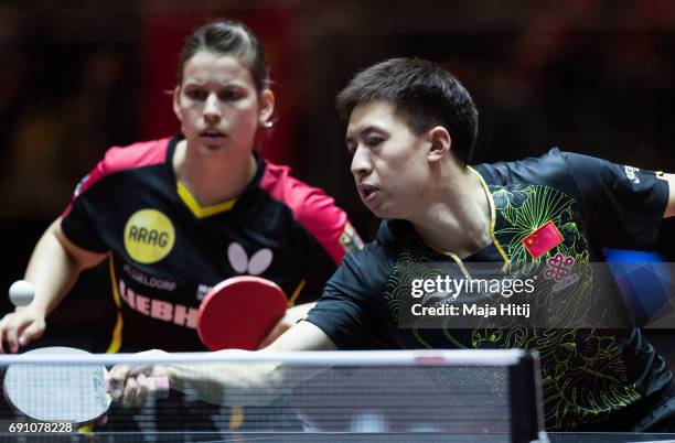 Fang Bo of China and Petrissa Solja of Germany during mixed double eighth-final at Messe Duesseldorf on June 1, 2017 in Dusseldorf, Germany.