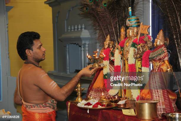 Tamil Hindu priest performs special prayers honouring Lord Murugan during a festival at a Tamil Hindu temple in Ontario, Canada.