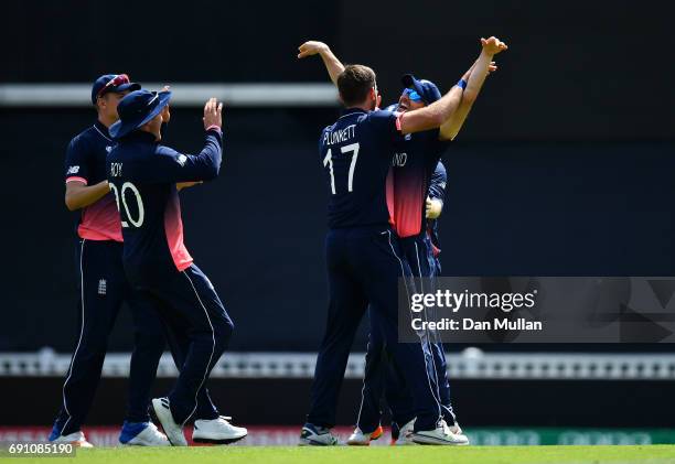 Liam Plunkett of England celebrates taking the wicket of Imrul Kayes of Bangladesh with Mark Wood of England during the ICC Champions Trophy Group A...