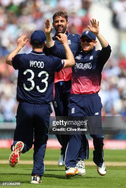 Liam Plunkett of England celebrates the wicket of Imrul Kayes of Bangladesh with Mark Wood during the ICC Champions trophy cricket match between...