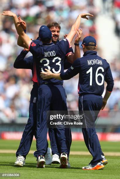 Liam Plunkett of England celebrates the wicket of Imrul Kayes of Bangladesh with Mark Wood during the ICC Champions trophy cricket match between...