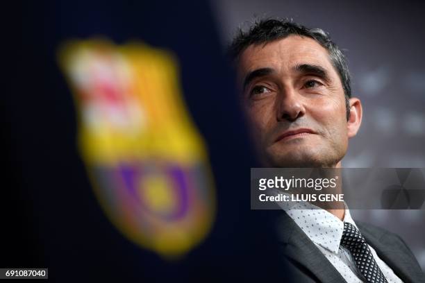 Barcelona's new coach Ernesto Valverde looks on as he gives a press conference during his official presentation in Barcelona on June 1 after signing...