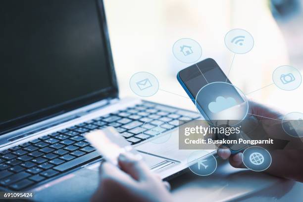 hands holding credit card and using smart phone. internet online shopping - credit risk stock pictures, royalty-free photos & images