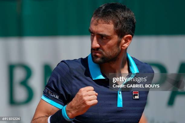 Croatia's Marin Cilic reacts after a point against Russia's Konstantin Kravchuk during their tennis match at the Roland Garros 2017 French Open on...