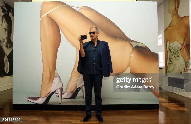 Peruvian Photographer Mario Testino poses in front of his photograph 'Vogue Italia, Paris, 2000' prior to the opening of the 'Mario Testino....